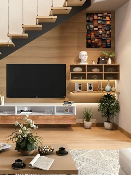 This TV unit is cleverly integrated under a staircase, maximizing usable space. The design includes open shelving with backlighting and closed cabinets, providing a perfect blend of function and style.