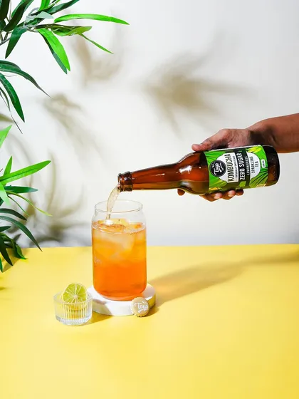 Adding a human element by showing the kombucha being poured. This action makes the product feel more engaging and ready to be enjoyed.