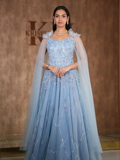 A modern, fashion-forward look featuring a pearl-encrusted gown. The simple diamond drop earrings are the perfect accessory for this statement outfit.