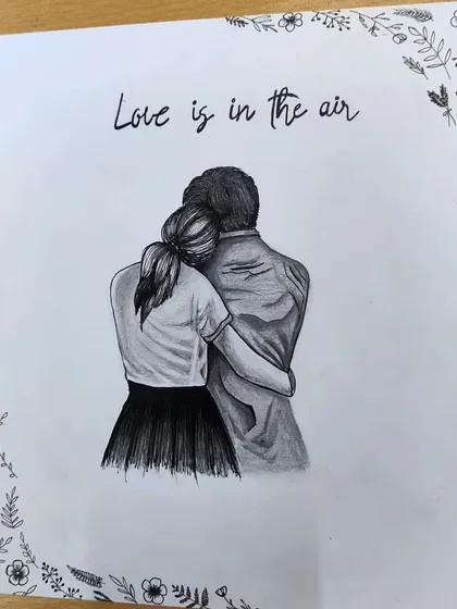 A clean, flat-lay view of the finished romantic couple drawing. The combination of the central portrait and the hand-drawn border makes it a complete and thoughtful piece.