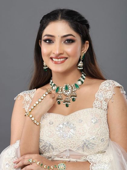 A happy, smiling portrait of the client, her makeup looking bright and radiant.