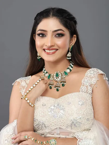 A happy, smiling portrait of the client, her makeup looking bright and radiant.
