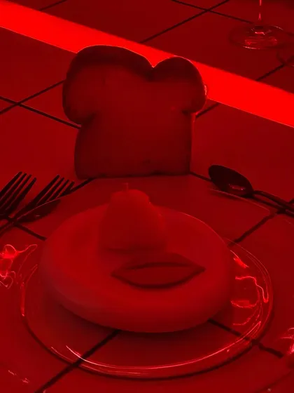 A surreal, red-lit shot of the playful butter and bread at the birthday dinner. The dramatic lighting was part of the overall mood we designed for the party.