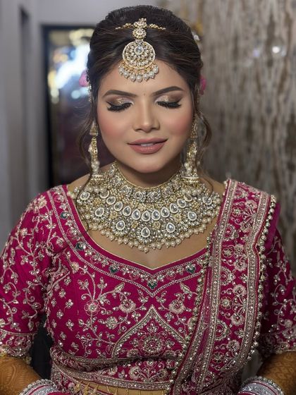 A close-up of the bride's soft glam makeup. The gold eyeshadow and nude-pink lip are a perfect combination for a modern yet traditional look.