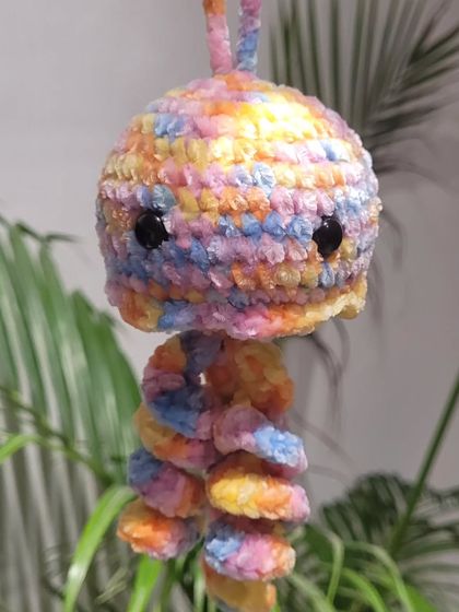 A clear, bright photo of my handmade jellyfish plushie. You can see the texture of the velvet yarn and the mix of pastel colors that make it so unique.