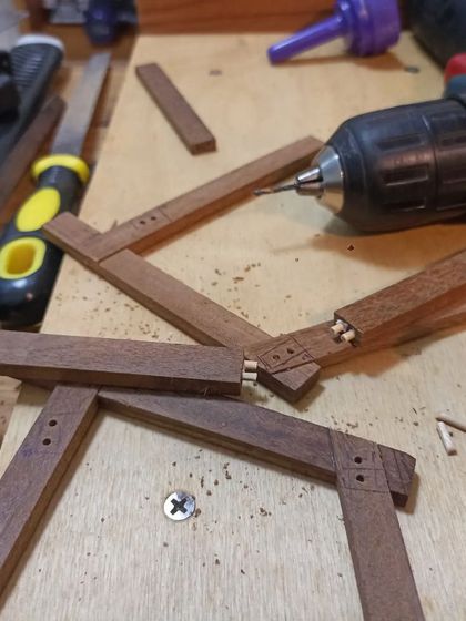 Making a miniature model of a chair. This process of creating small-scale prototypes helps in visualizing the final product and planning the construction steps.