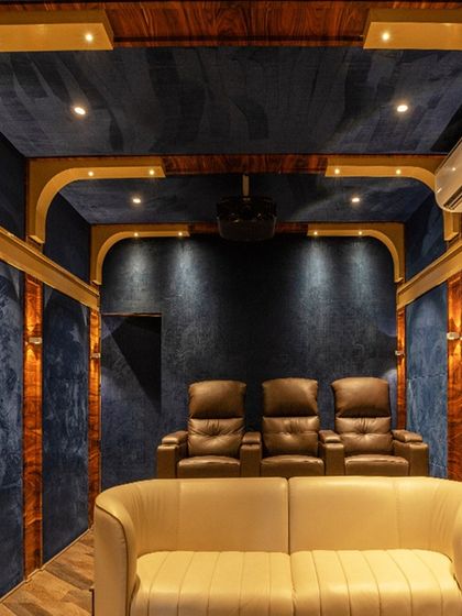 A view from the front sofa, looking towards the tiered recliner seating, perfect for hosting movie nights.