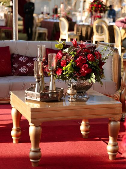 Another detail shot of the lounge seating, focusing on the textures. The combination of the plush sofa, the smooth metallic table, and the fresh flowers creates a tactile and visually interesting composition.