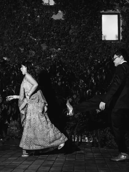 A fun, candid moment on the dance floor. This black and white shot captures the energy and movement of the reception party.