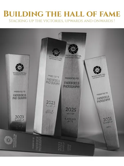 A black and white photograph showcasing our collection of WeddingSutra trophies from 2022 to 2025. Each award represents a story we were privileged to tell and our continuous journey of growth.