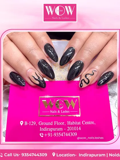 Edgy and chic, this design features a combination of glossy black nails and accent nails with snake and flame patterns on a neutral base. Perfect for a bold, statement-making look.