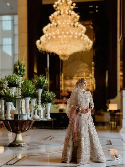 A grand bridal portrait in the opulent lobby of The Ritz-Carlton, Pune. A perfect example of a luxurious city destination wedding.