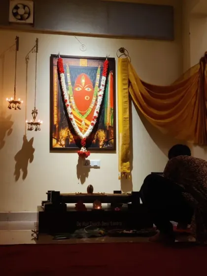 Two devotees bow before the Devi Avigna Yantra. In these moments of surrender, one can truly feel the embrace of the Divine Mother.