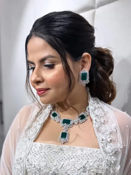 A close-up of the messy ponytail, accented with small pearl details for a touch of elegance.