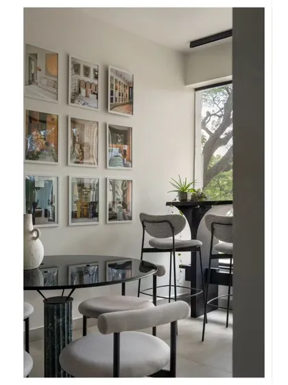 A quiet corner in our office for smaller meetings or a quick break. The gallery wall features images from our projects, reminding us of the stories we've helped create.