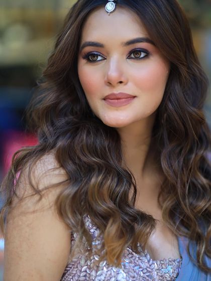 A close up of the model's face, showing how the soft waves beautifully frame her features.