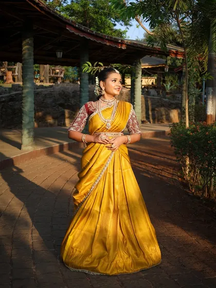 For a beautiful traditional look, I offer authentic South Indian half-sarees, also known as Langa Voni. This vibrant yellow silk piece is perfect for cultural functions or a unique pre-wedding photoshoot, and includes all the traditional temple jewellery you see here.