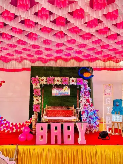 For a traditional Maharashtrian baby shower, or Dohale Jevan, I created this beautiful stage setup. It features a decorated jhula (swing), a large floral moon prop, and character cutouts of Radha and Krishna, all under a vibrant pandal ceiling.