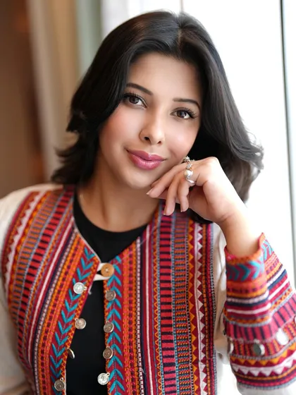 A simple way to create a fusion look is by layering a traditional piece over a modern base. Here, I've styled a vibrant Gujarati jacket over a simple black top for an effortlessly chic, Indo-Western outfit.