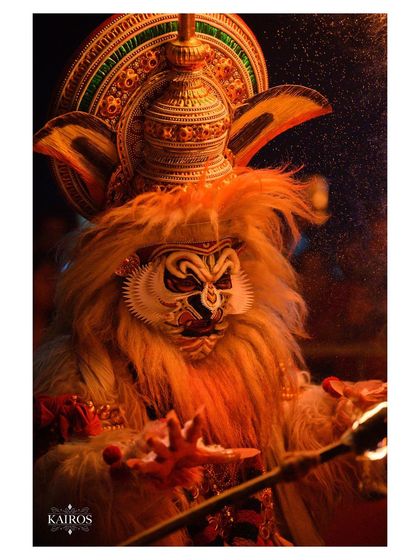 A dramatic portrait of a performer lit by fire, capturing an intense and primal energy.