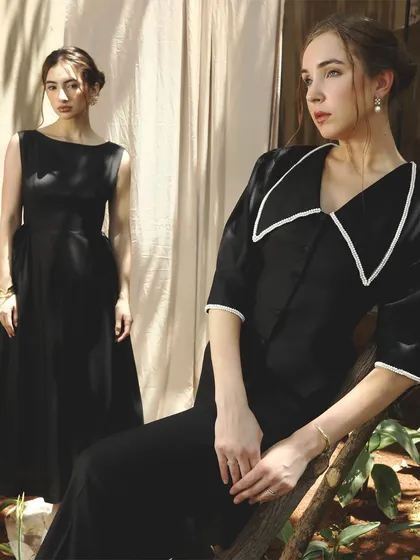 A striking shot featuring two models in black. The makeup is clean and classic, with a focus on defined features and flawless skin to create a look of sophisticated elegance. slight blush and a berry-toned lip.