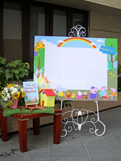 A custom Peppa Pig photo frame and a station for guests to leave their blessings for the birthday boy, Agastya.