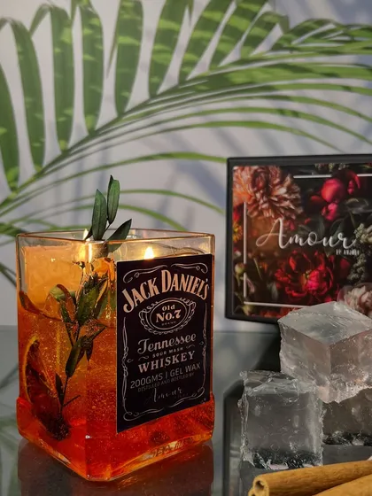 Not your regular nightcap, but it sure sets the mood. This Jack Daniels-inspired gel candle is handcrafted in an authentic JD bottle with dried botanicals for a rustic touch.