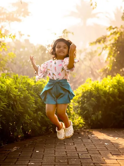 Life's greatest joys come in small packages. A jump for joy during her third birthday shoot perfectly captures the endless energy and happiness of being a child.
