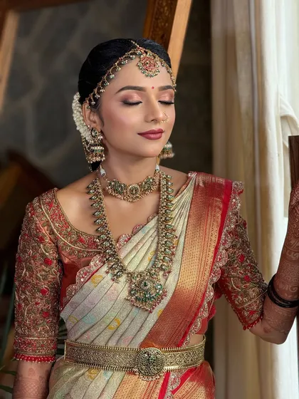 A serene portrait of the bride. The soft-focus eyeshadow and perfectly blended base give her a dreamy, ethereal glow for her special day.