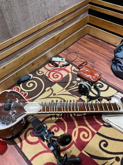 My sitar, headphones, and microphone ready for action in the studio corner. This is my workspace, where I translate ideas and emotions into music.
