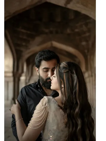 A close-up portrait that focuses purely on the couple's emotional connection. Set within the historic arches of a monument, this shot strips away the background to highlight a moment of quiet intimacy and love.