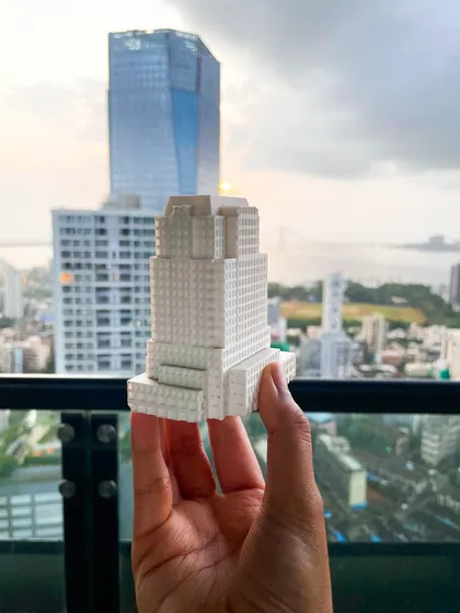 This 3D printed model of a high-rise building is held against the Mumbai skyline, demonstrating how we use physical models to study our designs in their future context. This step is vital for ensuring our projects complement and enhance the urban fabric.