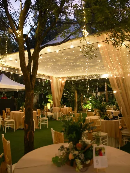 A collection of stunning wedding setups at The Farmhouse Collective. You can see the venue's versatility, from elegant morning ceremonies with floral mandaps to glamorous evening receptions with fairy lights and chic decor. This space is a blank canvas for your dream outdoor wedding in Bengaluru.