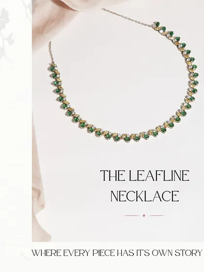 The Leafline Necklace, a statement of timeless elegance. This piece features a delicate line of emeralds, yellow sapphires, and diamonds, perfect for adding a touch of color to any outfit.
