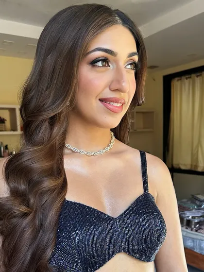 A three-quarter profile of Sheena, highlighting the beautiful contouring on her cheekbones and the soft finish of her hairstyle.