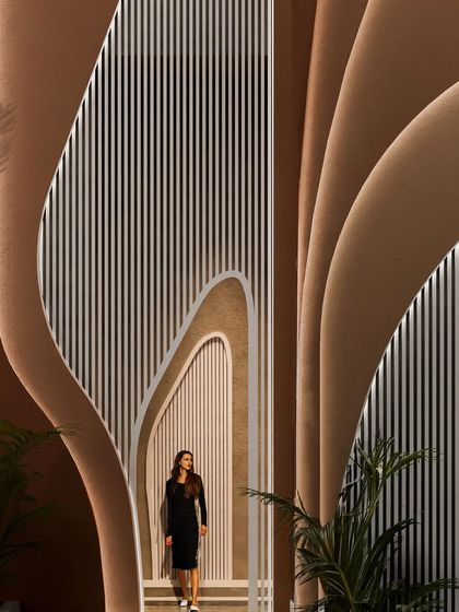 A view from within the "Water & Wind" residence, looking out through the fluid, organic openings that frame the exterior spaces.
