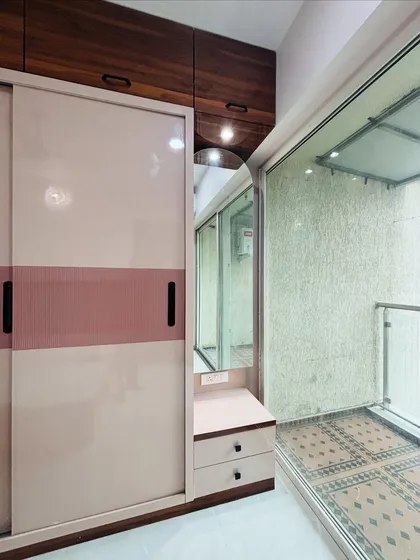 A close-up of the sliding wardrobe's integrated dressing table nook, complete with a mirror and drawers.