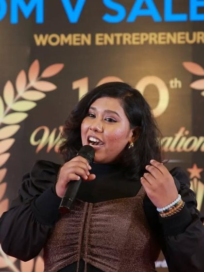 A shot of me addressing the audience. As a multilingual host, I can comfortably switch between English, Tamil, and Hindi to connect with everyone.