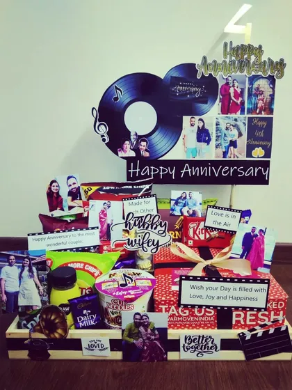 A music-themed anniversary hamper for a couple who shares a love for tunes. It features a vinyl record motif, personal photos, and a curated selection of their favorite snacks and treats.