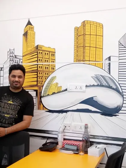 Here I am with a custom Chicago cityscape mural I painted for an office meeting room. This doodle-style art brings the city's iconic architecture, including the famous "Bean" sculpture, to life, adding a unique and personal touch to the workspace.