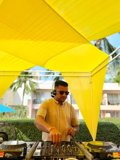 Behind the decks at a vibrant daytime event in Hua Hin, Thailand. The bright yellow decor matched the sunny, happy atmosphere of this destination wedding.