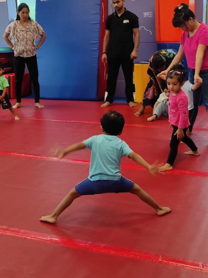A candid moment of children interacting during class. Our gym is a social space where friendships are formed while practicing physical skills.