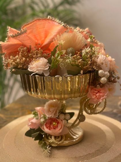 This Diwali, I'm focusing on gifts that are a mix of luxe, useful, and sustainable. This gorgeous golden urli is decorated with peach and cream flowers, making it a royal addition to any home.