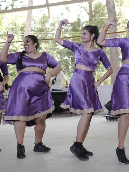 This crew's coordinated purple outfits and joyful expressions light up the stage.