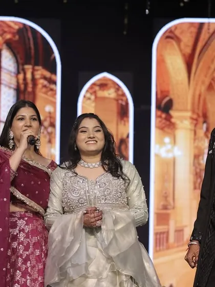 On stage with the lovely bride and groom. My job is to make them feel comfortable and celebrated as they share their special night with loved ones.