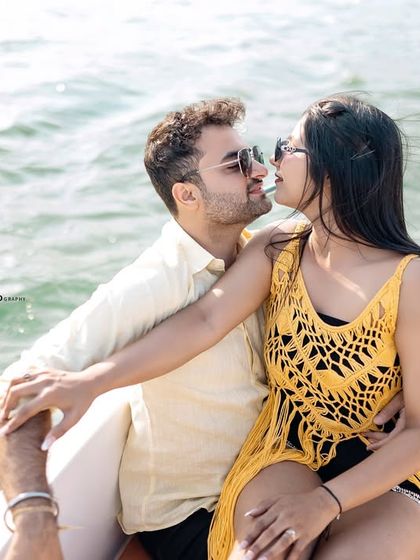 A happy, smiling embrace on the boat. The spray of the water and their genuine expressions capture the joy and excitement of the moment.