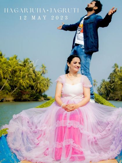 A fun and unique pre-wedding photo on a boat. The client is wearing a lovely pink and lavender ruffled gown that spreads out beautifully for a dramatic effect.