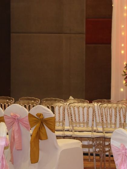 A view of the guest seating, showing a mix of classic chairs with bows and transparent ghost chairs, offering different styles for different areas of the venue.