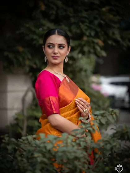 A portrait from a commercial jewelry shoot, where the model's elegant pose and the natural green background highlight the diamond necklace.