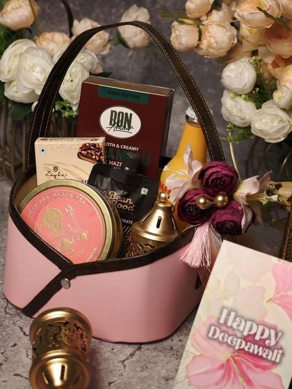 A chic pink leatherette basket filled with goodies. This is a stylish and reusable gift option for Diwali, perfect for friends or clients.